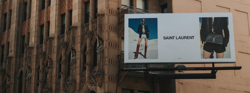 fashion billboard next to old building