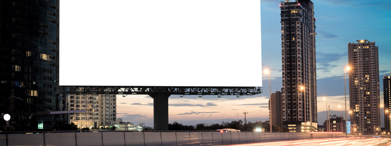 billboard next to highway and buildings